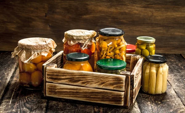 Preserves mushrooms and vegetables in a box. — Stock Photo, Image
