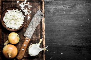 Eski bir balta ile kesme tahtası üzerinde soğan dilimlenmiş.