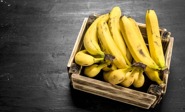 Ripe bananas in an old box.