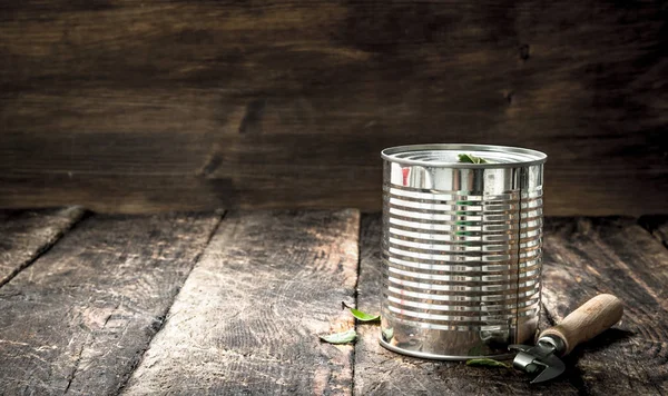 Food in tin can with opener.