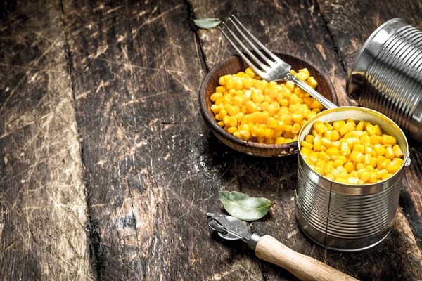 Canned corn in a tin can with opener.