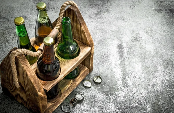 Old box with beer. On rustic background. — Stock Photo, Image