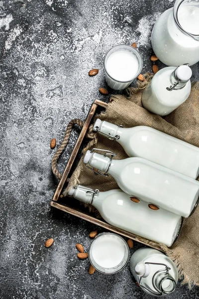 Milk background. Fresh milk in a wooden tray.