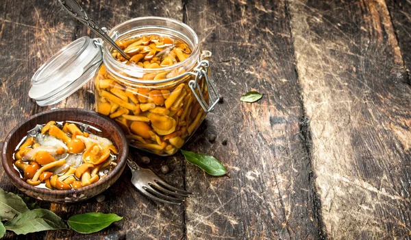 Pickled mushrooms in a bowl with spices and herbs. Royalty Free Stock Photos