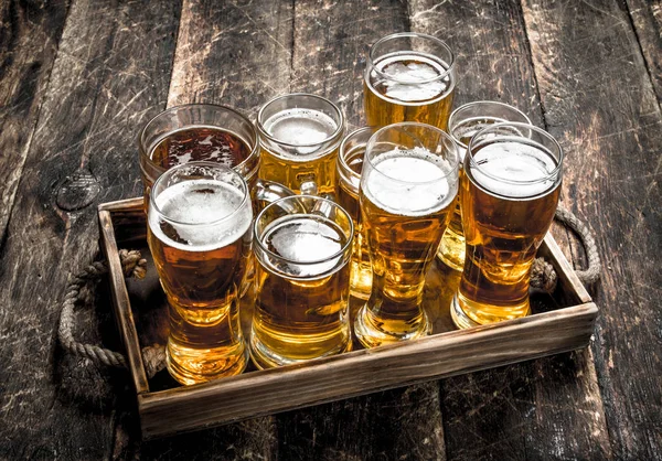 Glasses with fresh beer on an old tray. — Stock Photo, Image