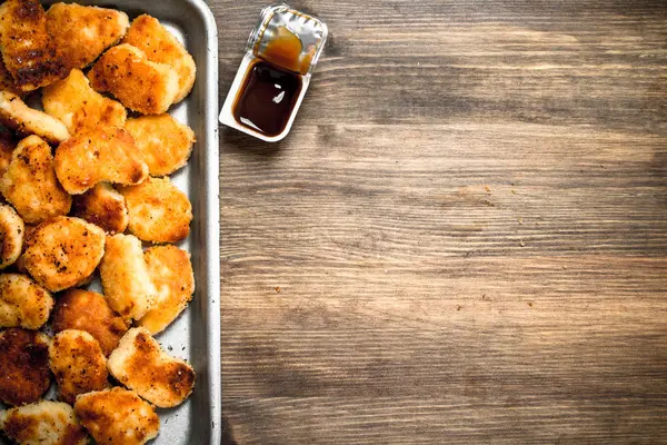 Chicken nuggets on a steel tray with sauce. — Stock Photo, Image