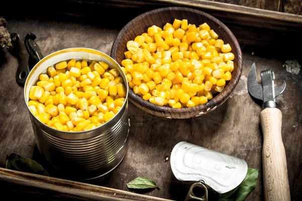 Canned corn in a tin can with opener.