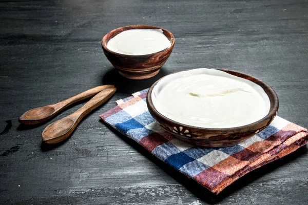 Natural milk yogurt in a bowl with a spoon.