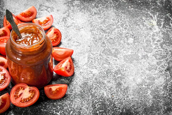 Tomato sauce in glass jar with spoon. — Stock Photo, Image