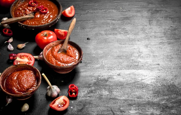 Tomato sauce with garlic in wooden bowls. — Stock Photo, Image