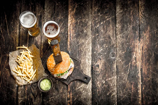 Street food. A big burger with beer.