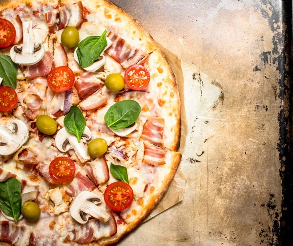 Fresh pizza with meat and tomatoes.