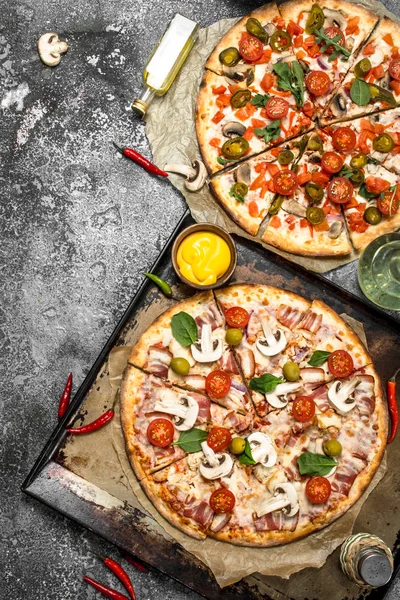 Fresh pizzas with meat and vegetables.