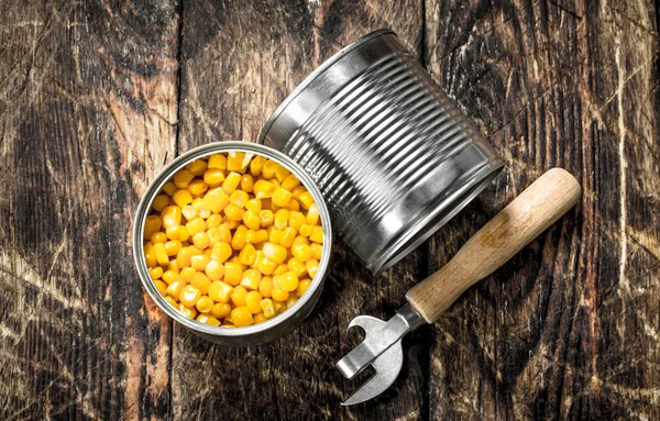 Canned corn in a tin can with opener.