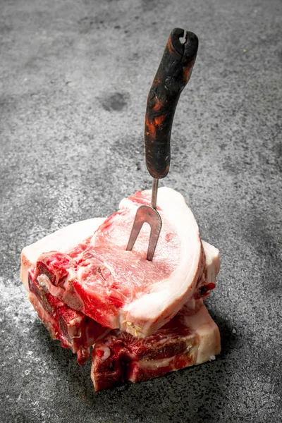 Filetes Cerdo Crudos Con Tenedor Sobre Fondo Rústico — Foto de Stock