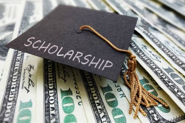 Scholarship cap on money clipart