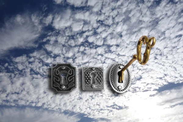 Gold key opening a sky lock