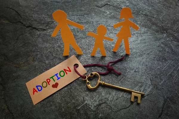 Paper family gold Adoption key — Stock Photo, Image