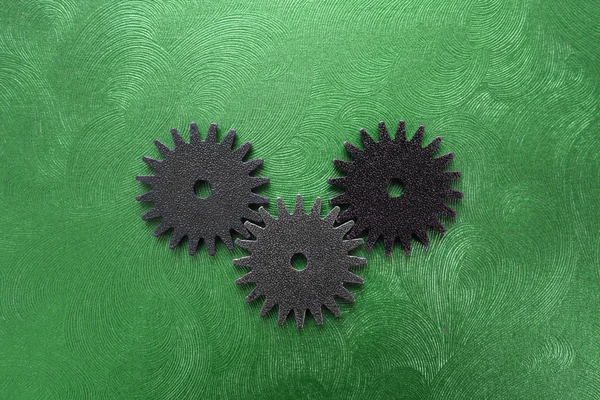 Three gears on green
