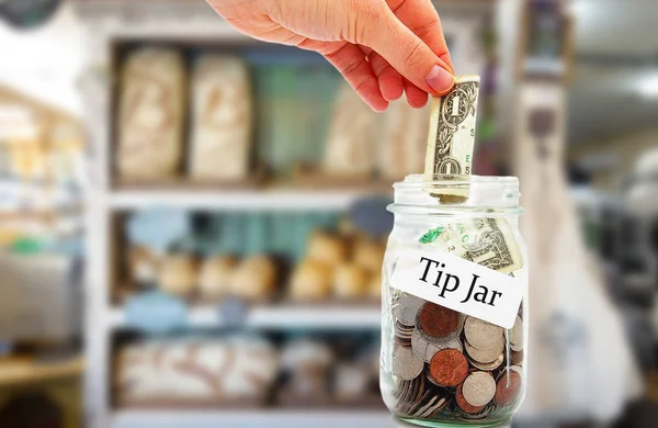 Tip jar money in a restaurant — Stock Photo, Image