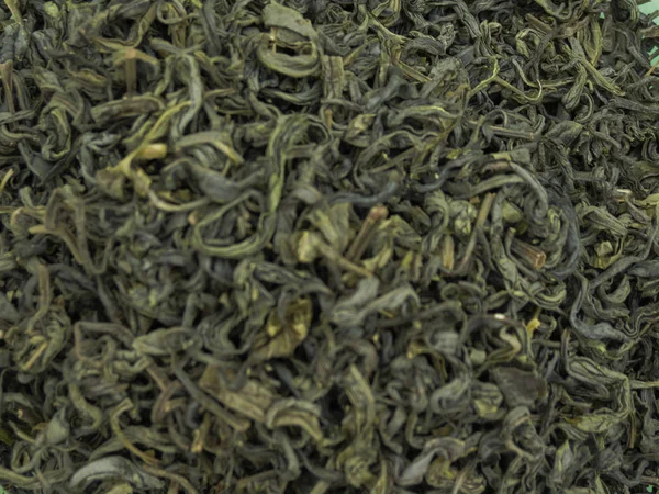 Loose green tea leaves useful as a background