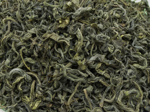 Loose green tea leaves useful as a background