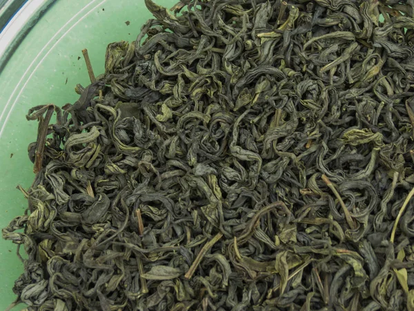 Loose green tea leaves useful as a background