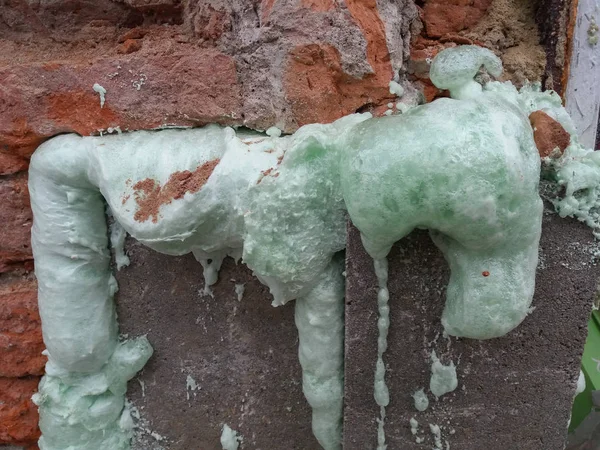 green spray foam insulation in a wall to save energy