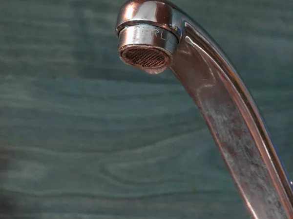 Kitchen sink tap with water drop dripping