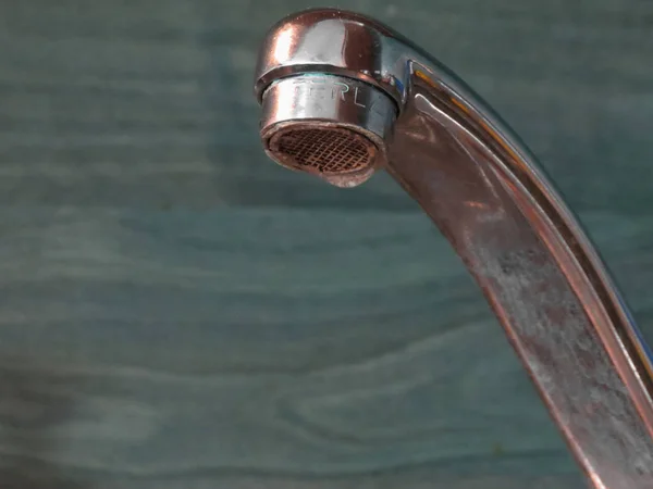 Kitchen sink tap with water drop dripping