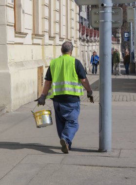 Brno, Çek Cumhuriyeti - Mart 2012 yaklaşık: yol işçi sarı boya bir kova ile