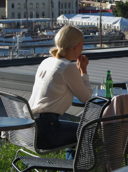 Oslo, Norveç - yaklaşık Ağustos 2017: tanımlanamayan sarışın kız bir barda oturan tablo