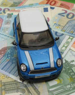 Oxford, İngiltere - Mayıs 2017 yaklaşık: Çin, çocuk oyuncak 2014, yaklaşık olarak Eur Notlar arka plan üzerinde üretilen hafif mavi Mini Cooper araba (2013 sürümü) minyatür gösterimi