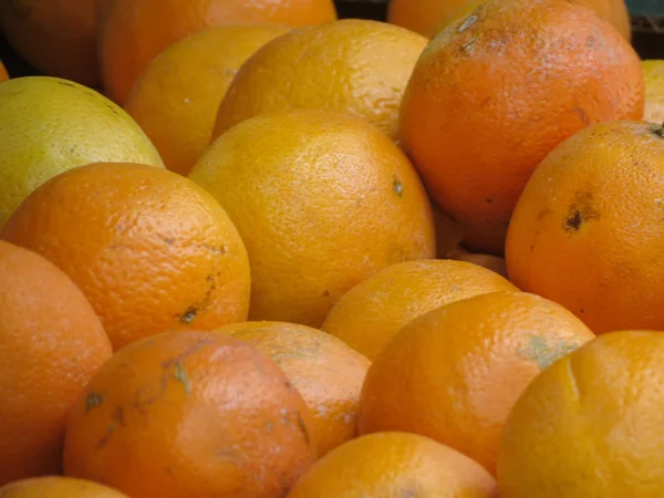 Oranges on display for sale on a market counter