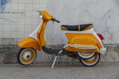 COIMBRA, PORTUGAL - CIRCA JUNE 2015: orange Italian Vespa 50 scooter motorcycle