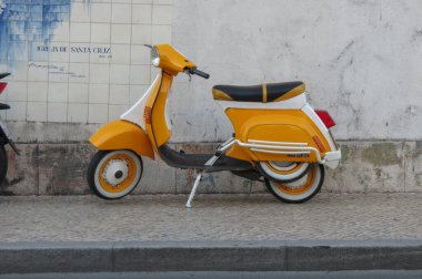 COIMBRA, PORTUGAL - CIRCA JUNE 2015: orange Italian Vespa 50 scooter motorcycle