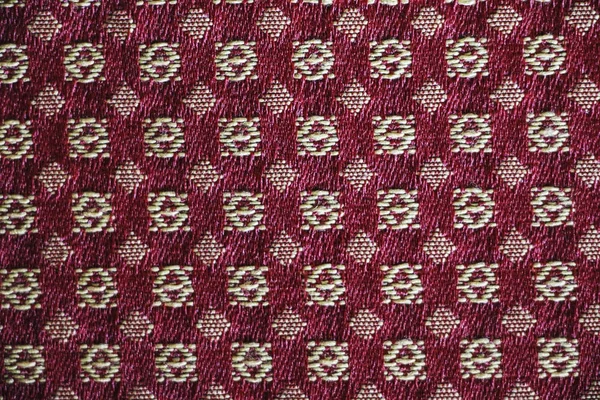 Textura de um tecido com um padrão geométrico de co vermelho e branco — Fotografia de Stock