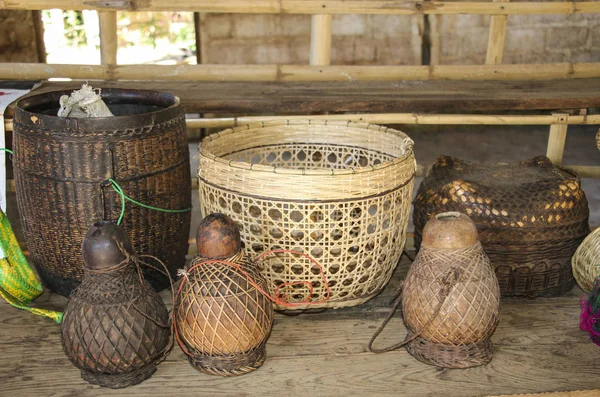 Wicker baskets and jugs for water on a wooden table — Stock Photo, Image