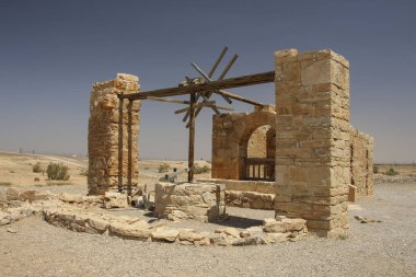 Ancient water well in castle Qasr Amra, desert castle near Amman clipart