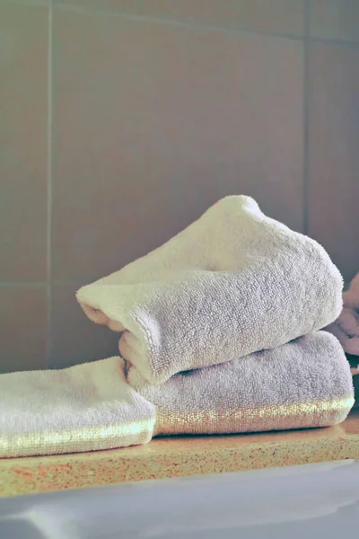 Concepto de higiene. Montón de toallas blancas limpias en el borde del baño . — Foto de Stock