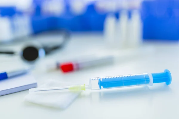 Syringe and vaccine front of a laboratory scene. Health care and medical