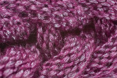 Süveter ya da atkı deseni büyük örgü. Örülmüş forma ve kabartma desenli. Örgü ören örgüler. Yün el örgüsü mü yoksa makine örgüsü mü? Kumaş Arkaplanı.