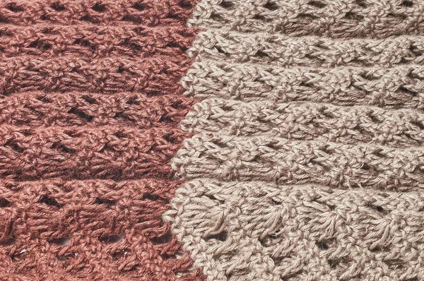 Sweater or scarf texture large knitting. Knitted jersey background with a relief pattern. Braids in knitting. Wool hand-knitted or machine knitting pattern. Fabric Background.