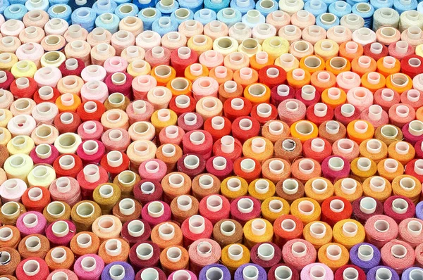 A set of threads of different colors. Many threads for sewing and needlework are different in color and size. Multicolored palette of threads.