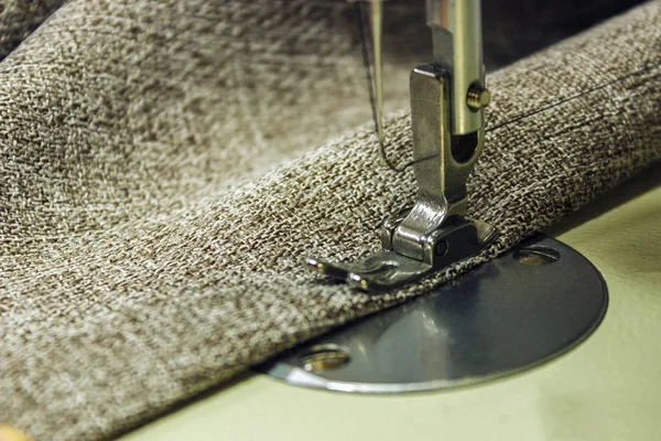 Denim kumaş dikiş makinesi üzerinde. Dikiş prosedürü Close-Up