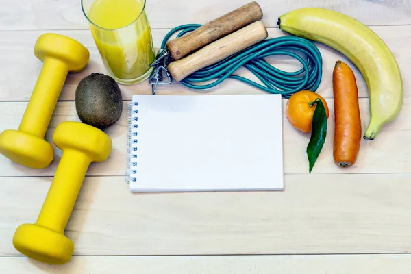 The concept of a way of life. Dumbbells, a glass of orange juice