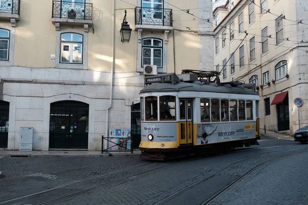 Traditional yellow tram at old streets — Stock Photo, Image
