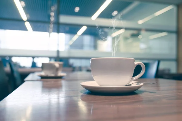 White cup of coffee at the cafe interior — Stock Photo, Image