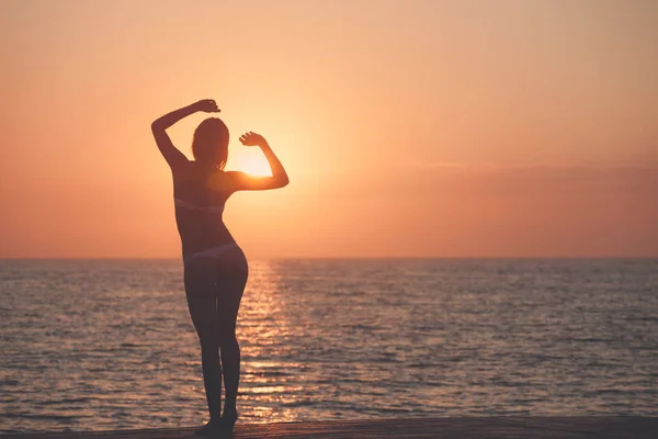 Frumoasa femeie silueta peste ocean răsărit de soare fundal — Fotografie, imagine de stoc