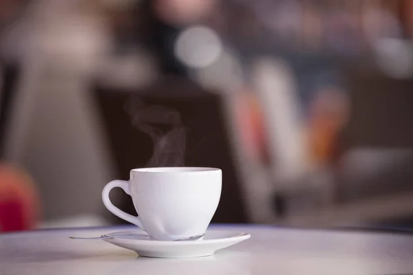 White cup of coffee on the cafe table — Stock Photo, Image